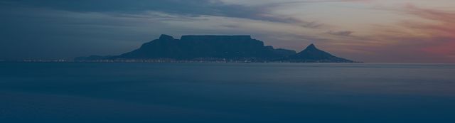 Photo of Table Mountain, Cape Town at sunset across a bay